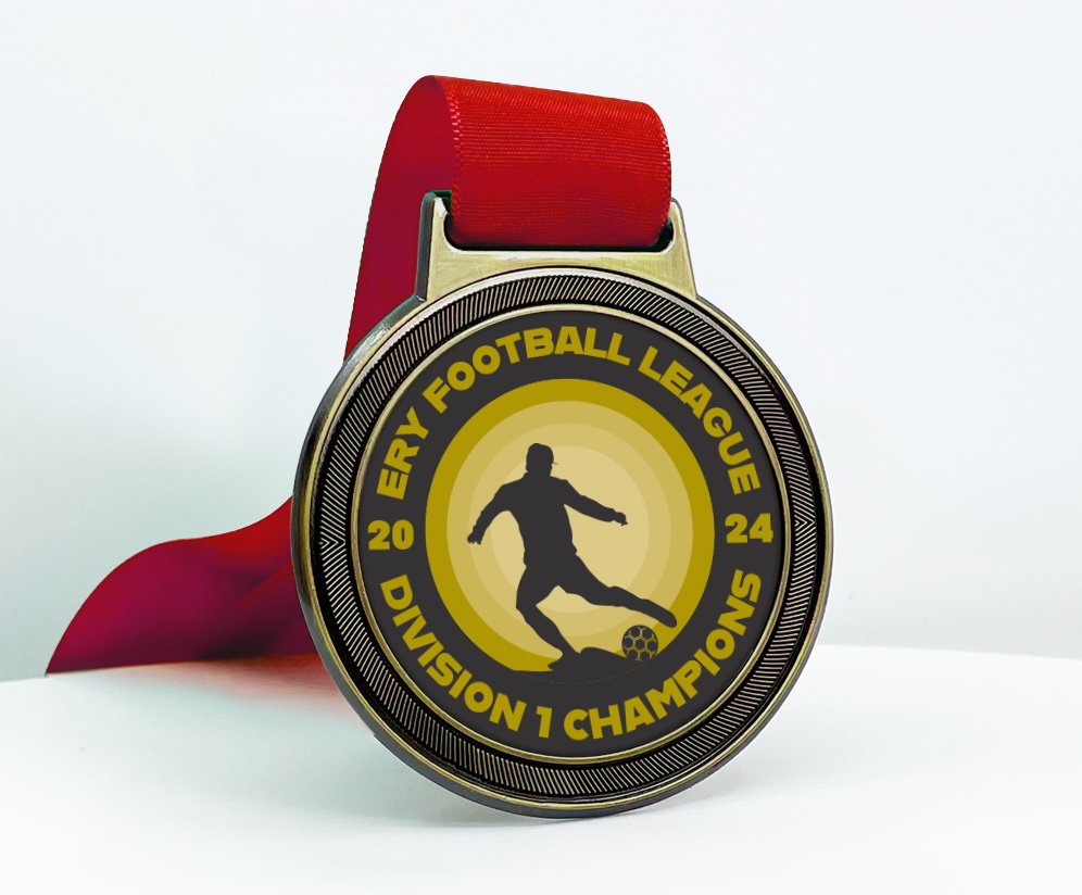 Gold-toned football medal with red ribbon for ERY Football League Division 1 Champions 2024.