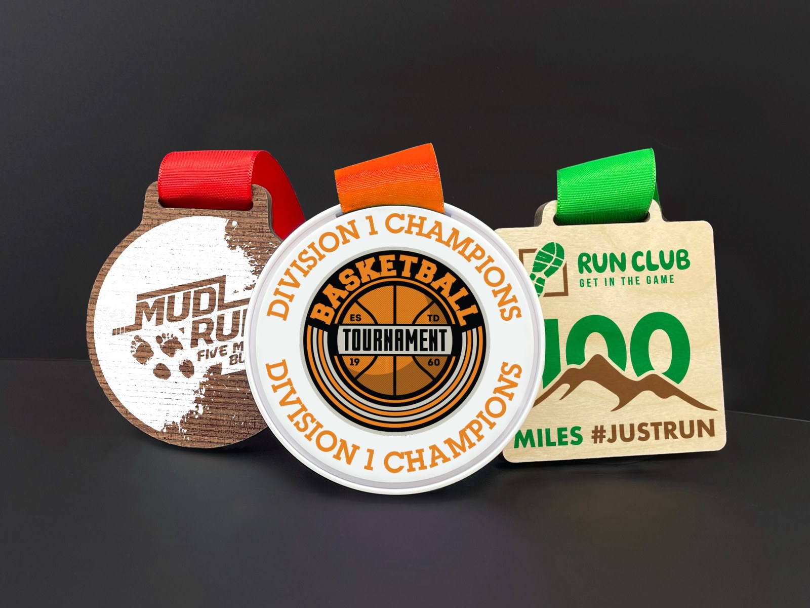 Three custom eco wooden medals with colourful printed designs and coloured ribbons