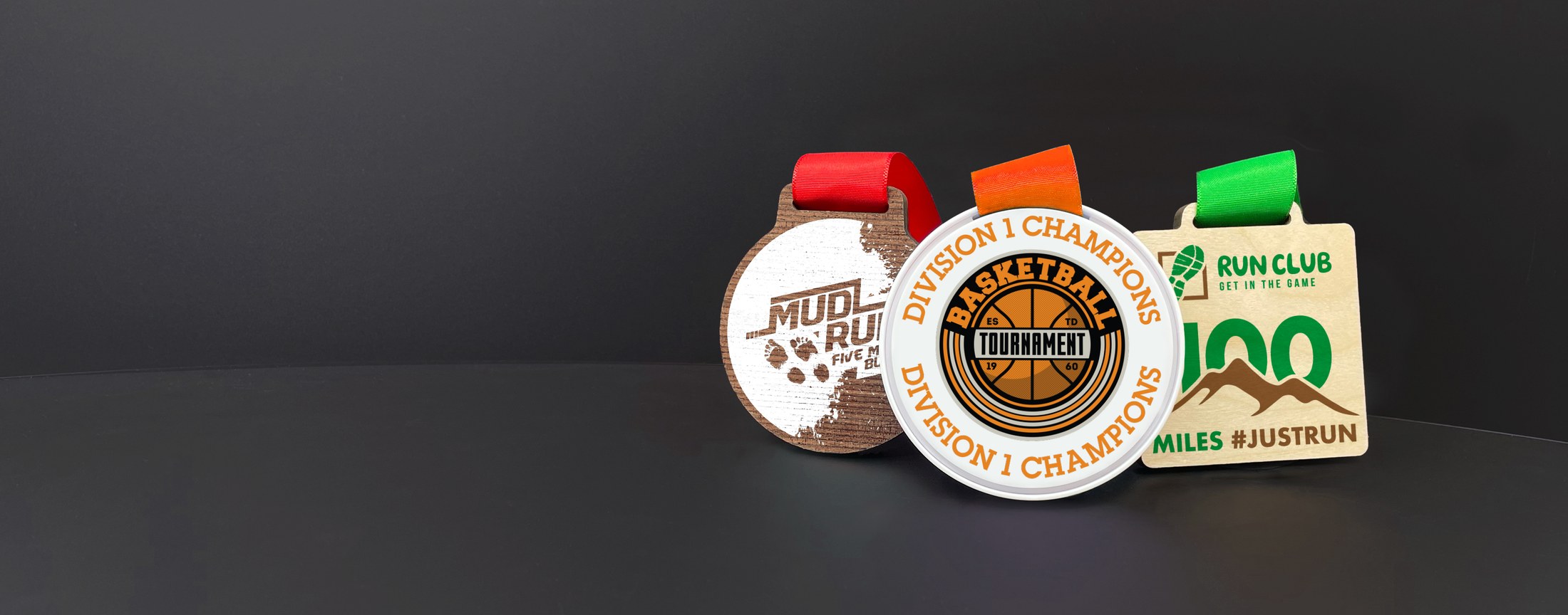A group of custom eco wooden medals on coloured ribbons