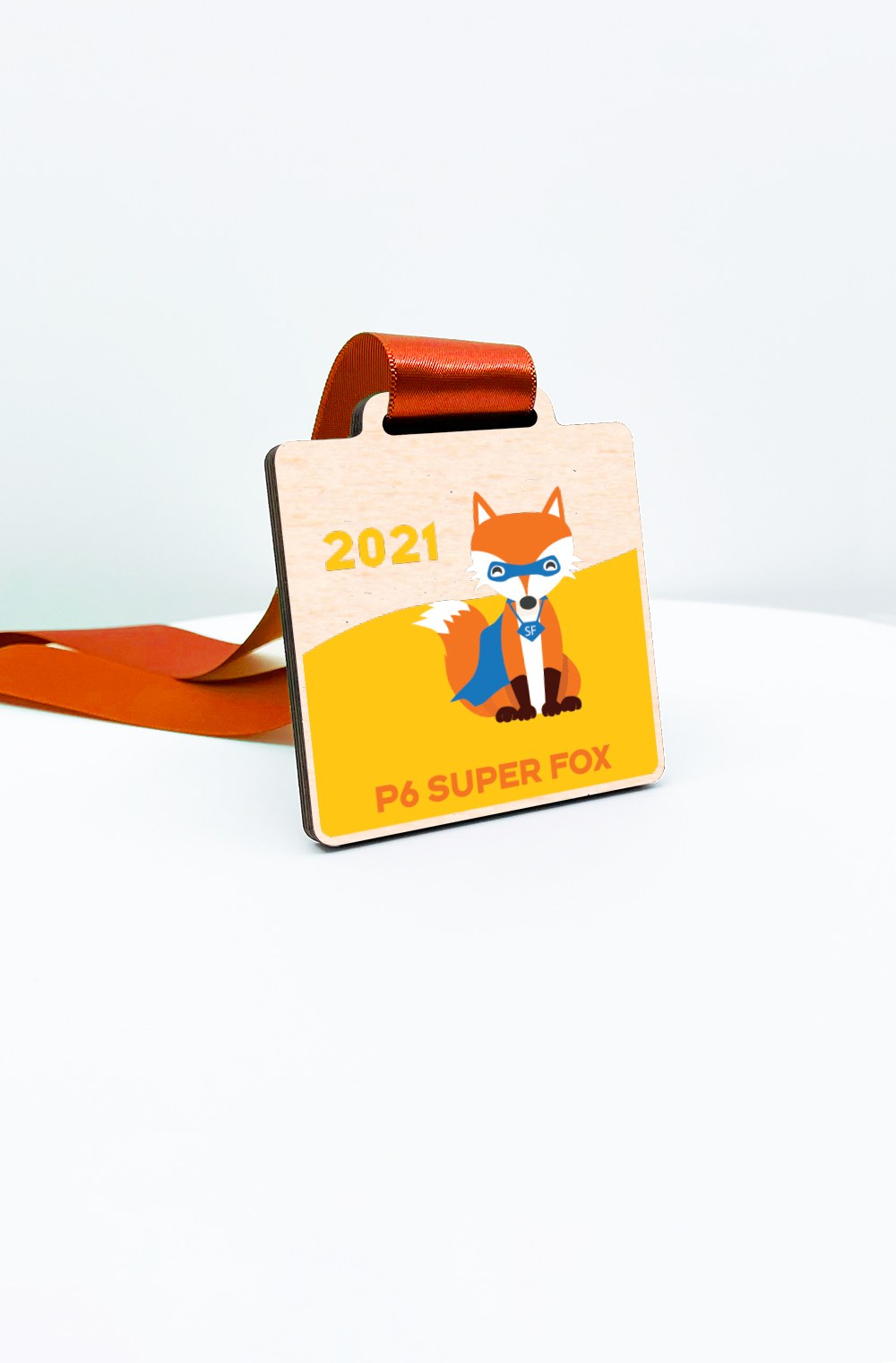 A personalised eco wooden medal printed with a class name and year